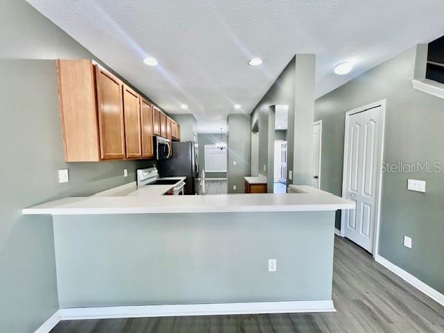 15655 Stable Run Drive Spring Hill, FL 34610 - Photo 15 of 48 a large kitchen with kitchen island a large counter top space a sink a refrigerator and a window