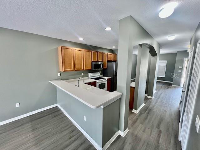15655 Stable Run Drive Spring Hill, FL 34610 - Photo 16 of 48 a kitchen with a refrigerator sink and wooden floor