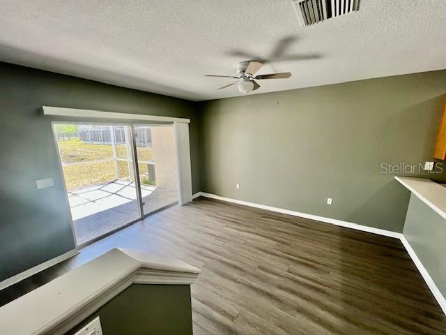 15655 Stable Run Drive Spring Hill, FL 34610 - Photo 20 of 48 an empty room with wooden floor and windows
