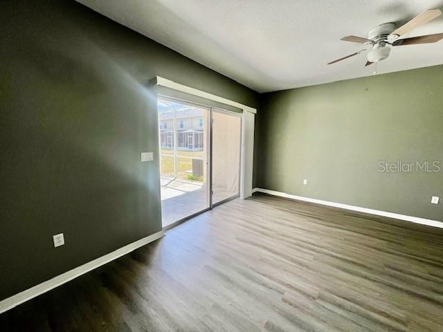 15655 Stable Run Drive Spring Hill, FL 34610 - Photo 21 of 48 an empty room with wooden floor and windows
