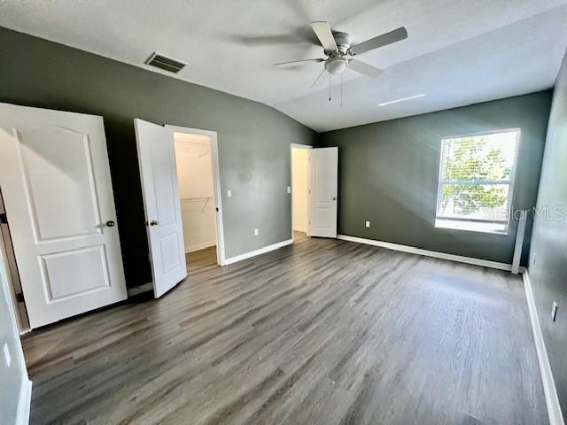 15655 Stable Run Drive Spring Hill, FL 34610 - Photo 24 of 48 an empty room with wooden floor and a window