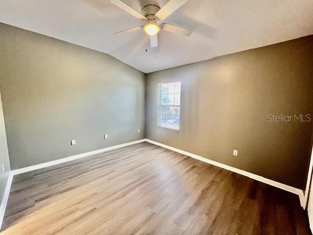 15655 Stable Run Drive Spring Hill, FL 34610 - Photo 31 of 48 wooden floor in an empty room with a window
