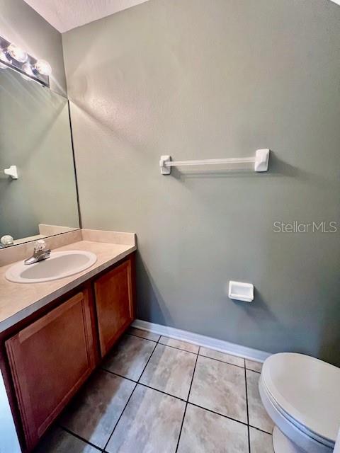 15655 Stable Run Drive Spring Hill, FL 34610 - Photo 38 of 48 a bathroom with a sink a toilet and a mirror