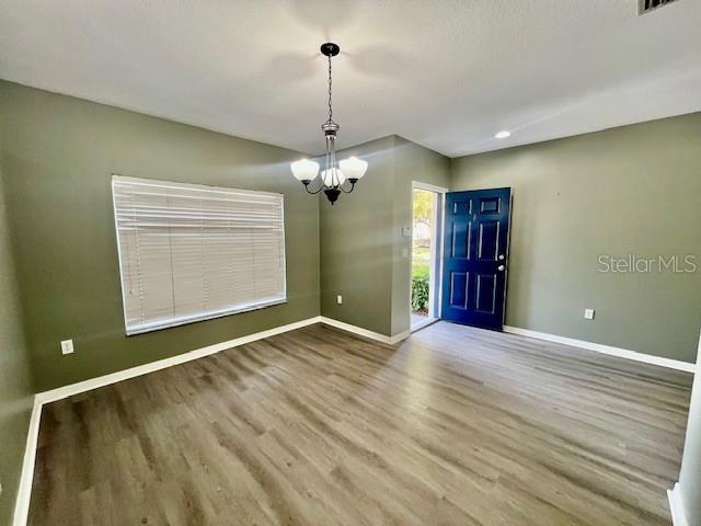 15655 Stable Run Drive Spring Hill, FL 34610 - Photo 7 of 48 a view of an empty room with wooden floor and a window