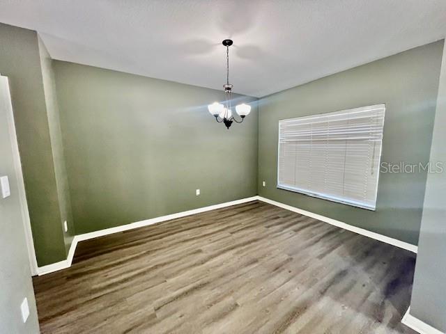 15655 Stable Run Drive Spring Hill, FL 34610 - Photo 8 of 48 a view of a room with wooden floor and white walls