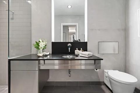 a living room with a table and a potted plant