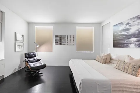 a room with a bed and a television