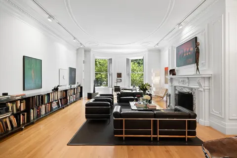 a living room with furniture fireplace and windows