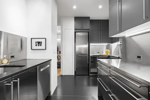 a kitchen with a refrigerator and a sink