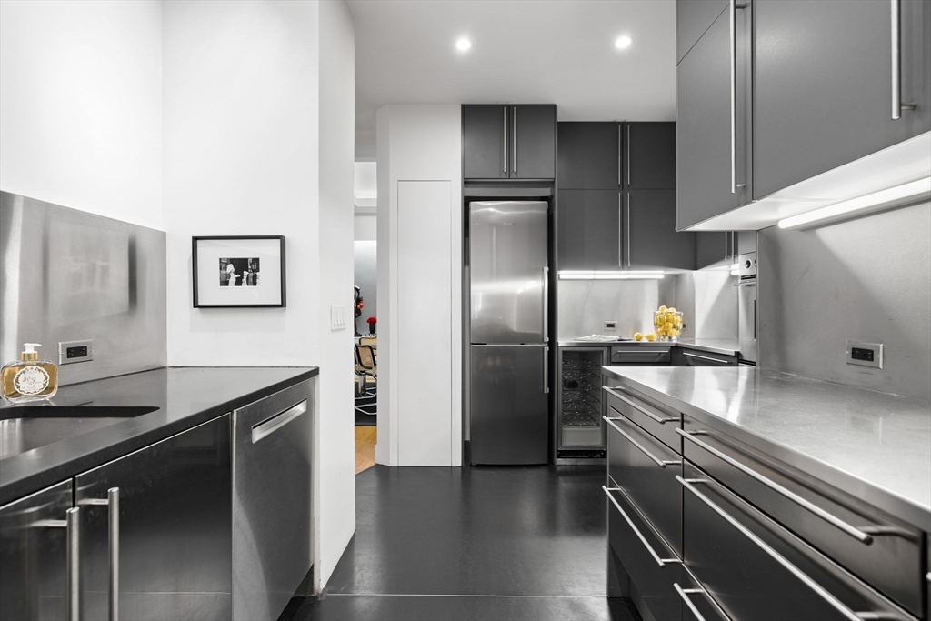 175 Commonwealth Avenue, Unit B Boston, MA 02116 - Photo 9 of 25 a kitchen with a refrigerator and a sink