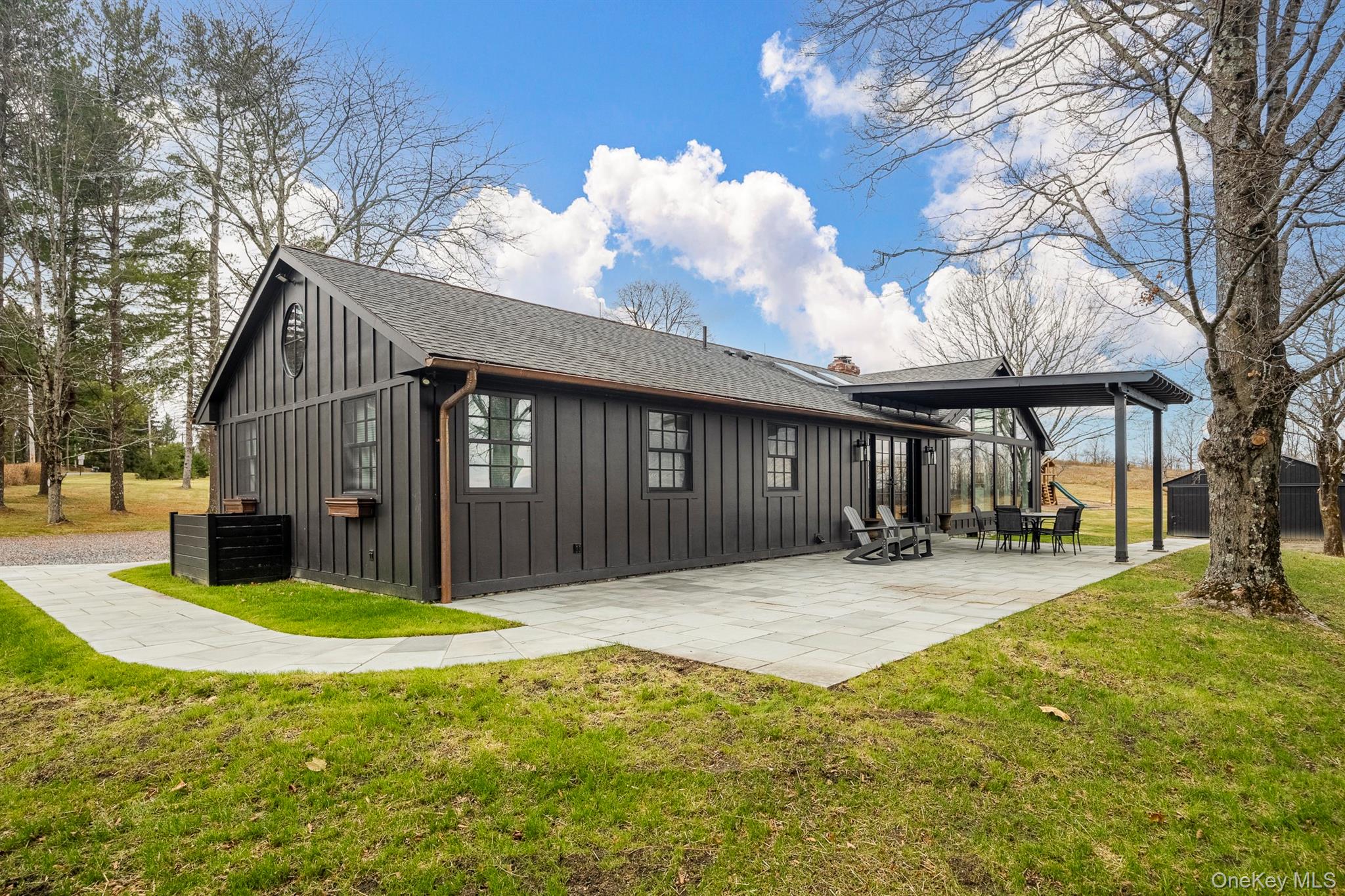 97 Valley Farm Road Millbrook, NY 12545 - Photo 35 of 48 a view of a house with floor to ceiling windows and a basket ball poll