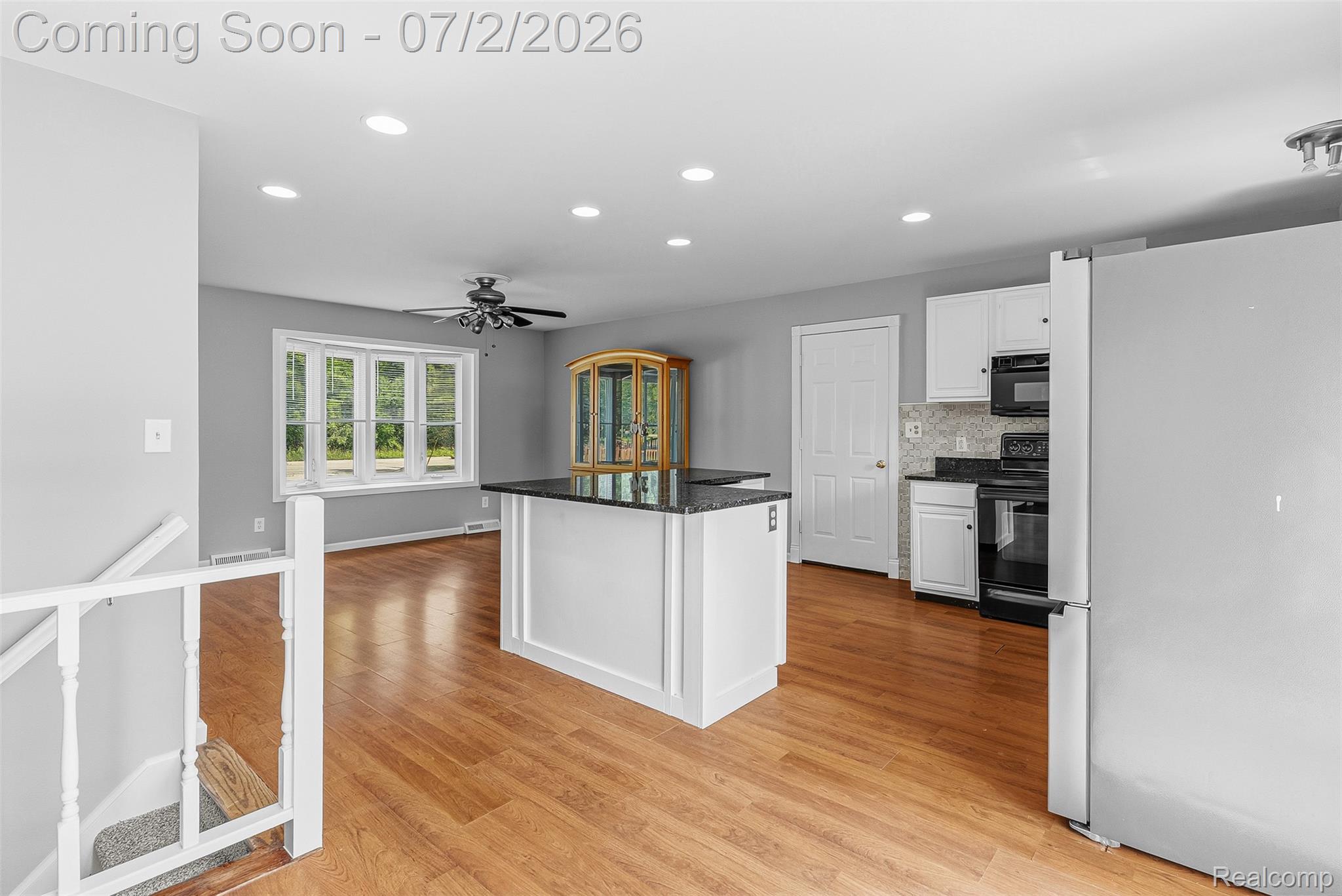 305 East Road Holly, MI 48442 - Photo 14 of 41 Open-concept space featuring wood-finish flooring, recessed lighting, and a kitchen island with a dark countertop