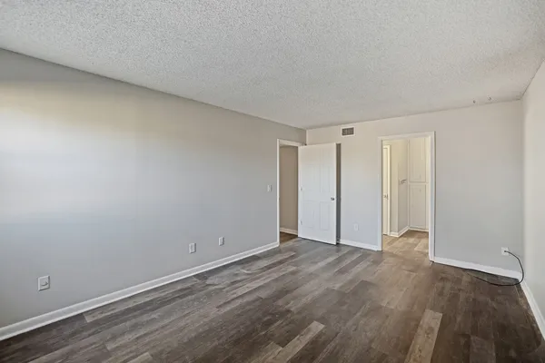 a view of an empty room and wooden floor