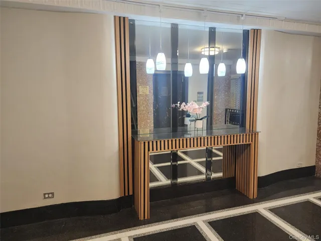 a view of staircase with railing and chandelier