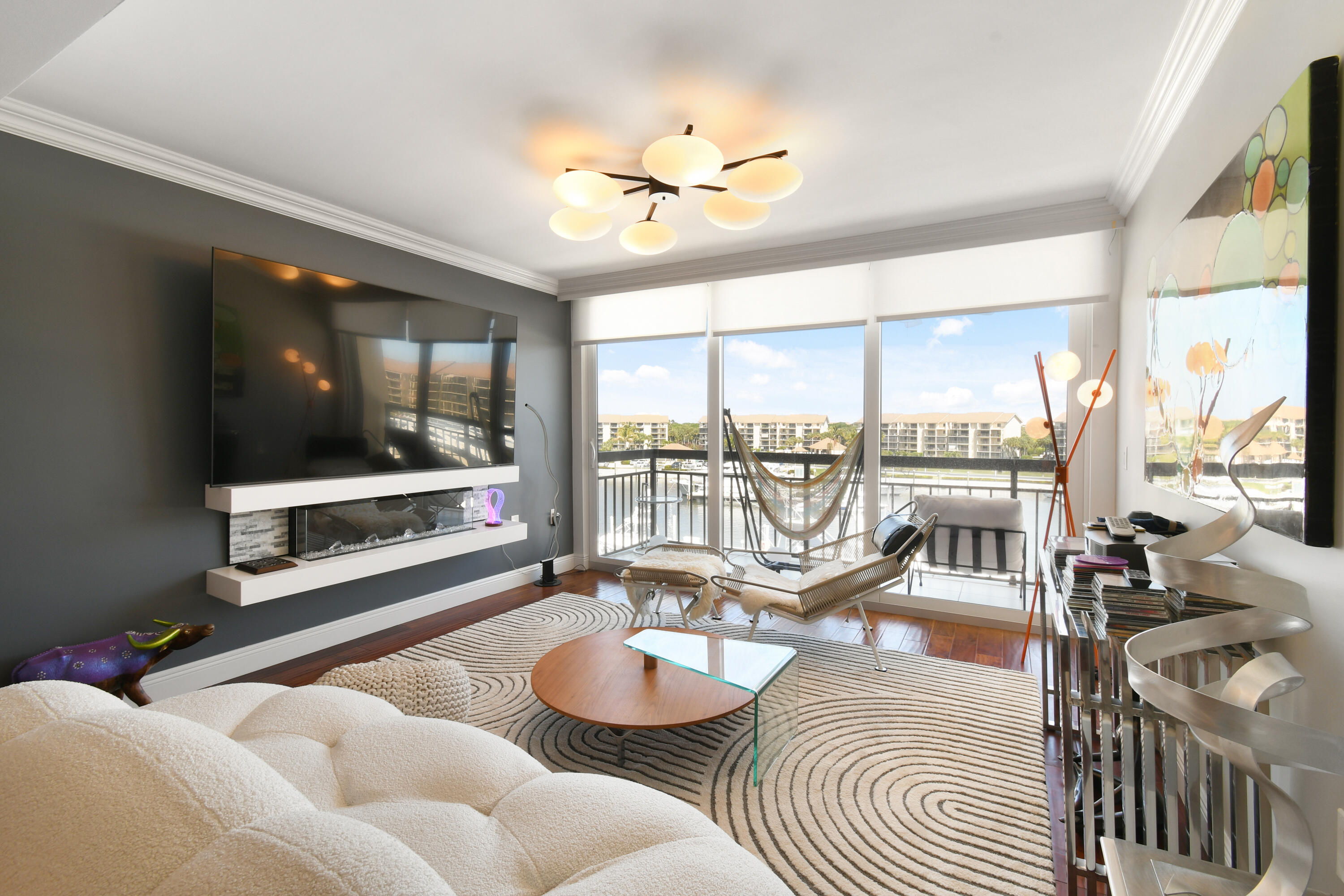 2401 Marina Isle Way, Unit 503 Jupiter, FL 33477 - Photo 11 of 46 a living room with furniture and a flat screen tv