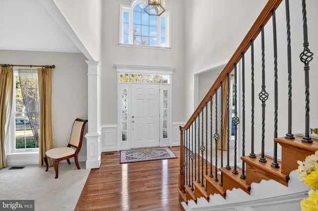 a view of an entryway with wooden floor and stairs