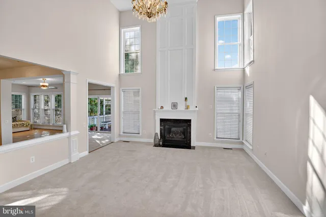 a view of livingroom with furniture fire place and windows