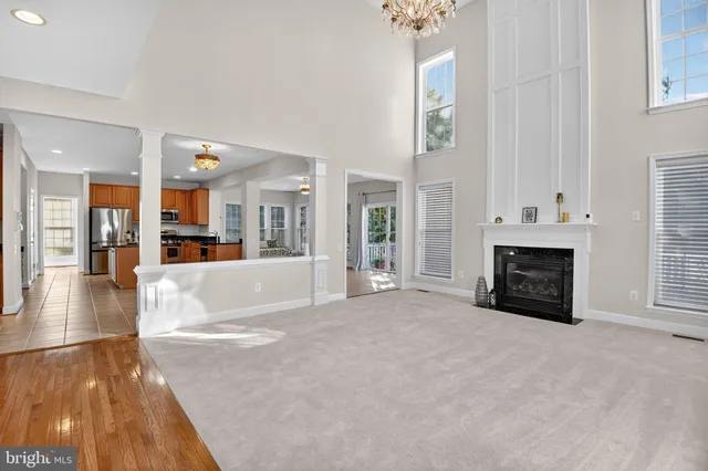a view of a livingroom with fireplace and window
