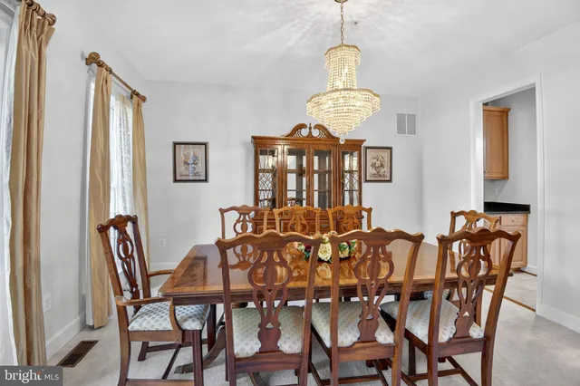 a view of a dining room with furniture wooden floor and chandelier