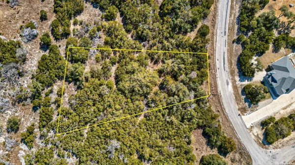 an aerial view of residential houses with city view