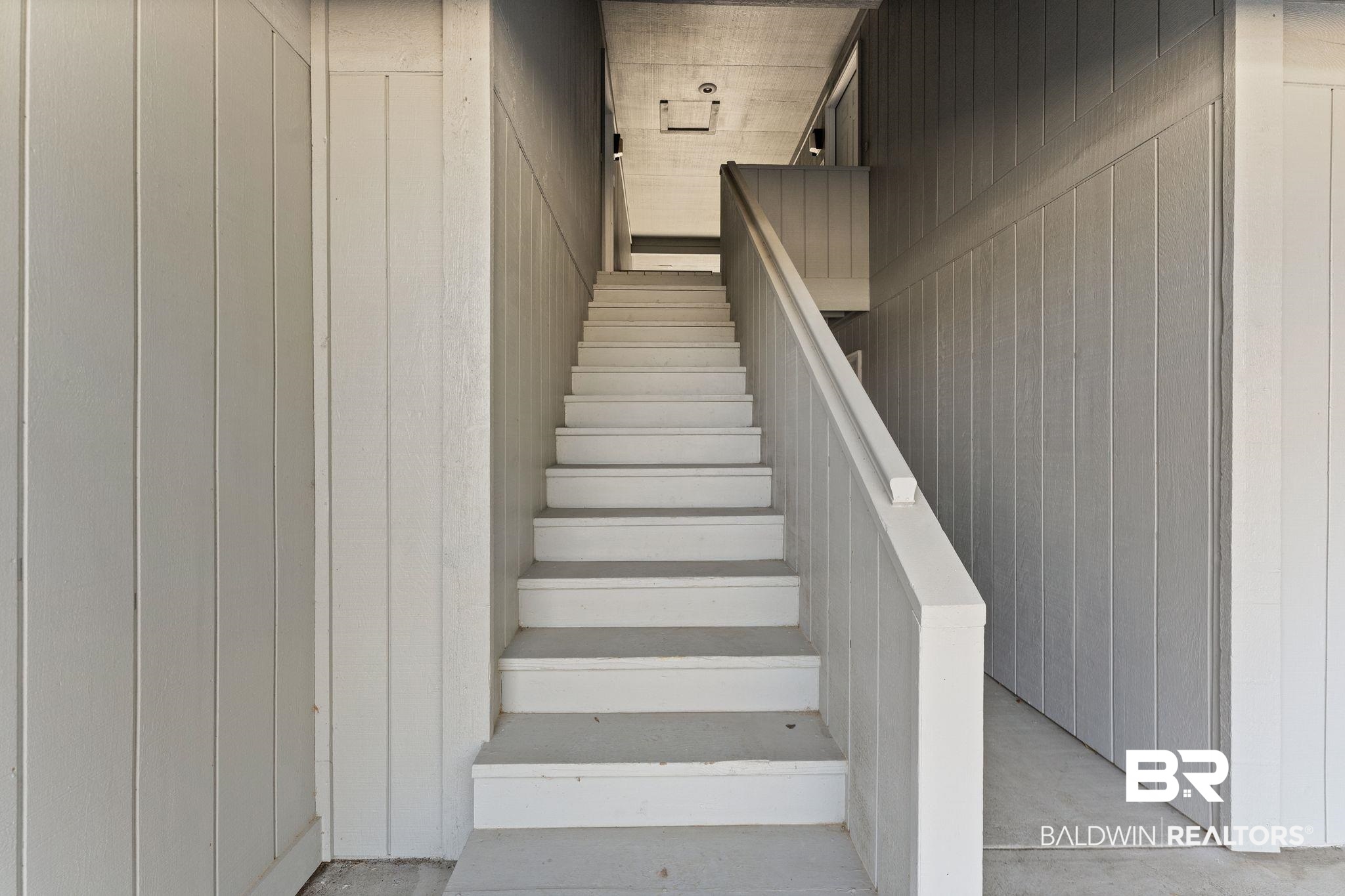 128 West Satsuma Avenue, Unit 128 Foley, AL 36535 - Photo 3 of 41 Staircase featuring concrete flooring