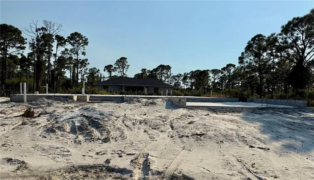 a view of yard covered with snow in the background