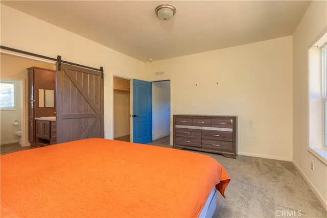 a bedroom with a bed and cabinets