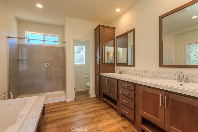a spacious bathroom with a double vanity sink mirror and shower