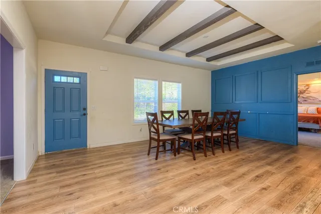 a view of a dining room with furniture and chandelier