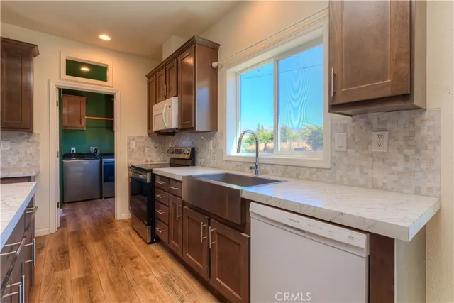 a kitchen with stainless steel appliances granite countertop a sink stove and cabinets