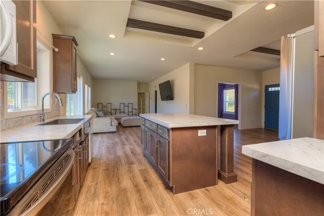 a kitchen with counter top space and wooden floor
