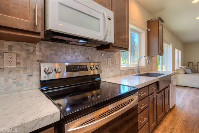 a kitchen with wooden cabinets and a stove top oven