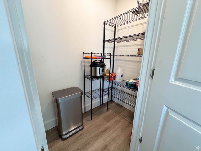 1486 West 2055th Street South Logan, UT 84339 - Photo 14 of 45 Pantry featuring light-toned walls, wood-finish flooring, and multi-tiered wire shelving for storage