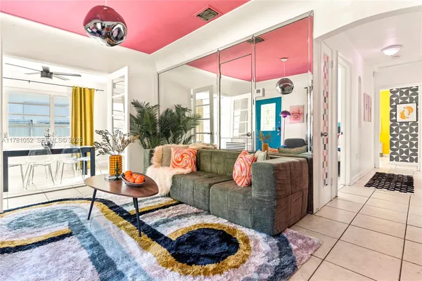 a living room with furniture and a floor to ceiling window