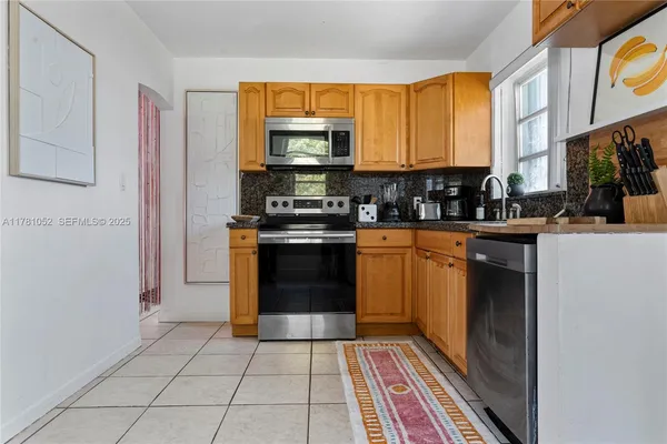 a kitchen with refrigerator and window