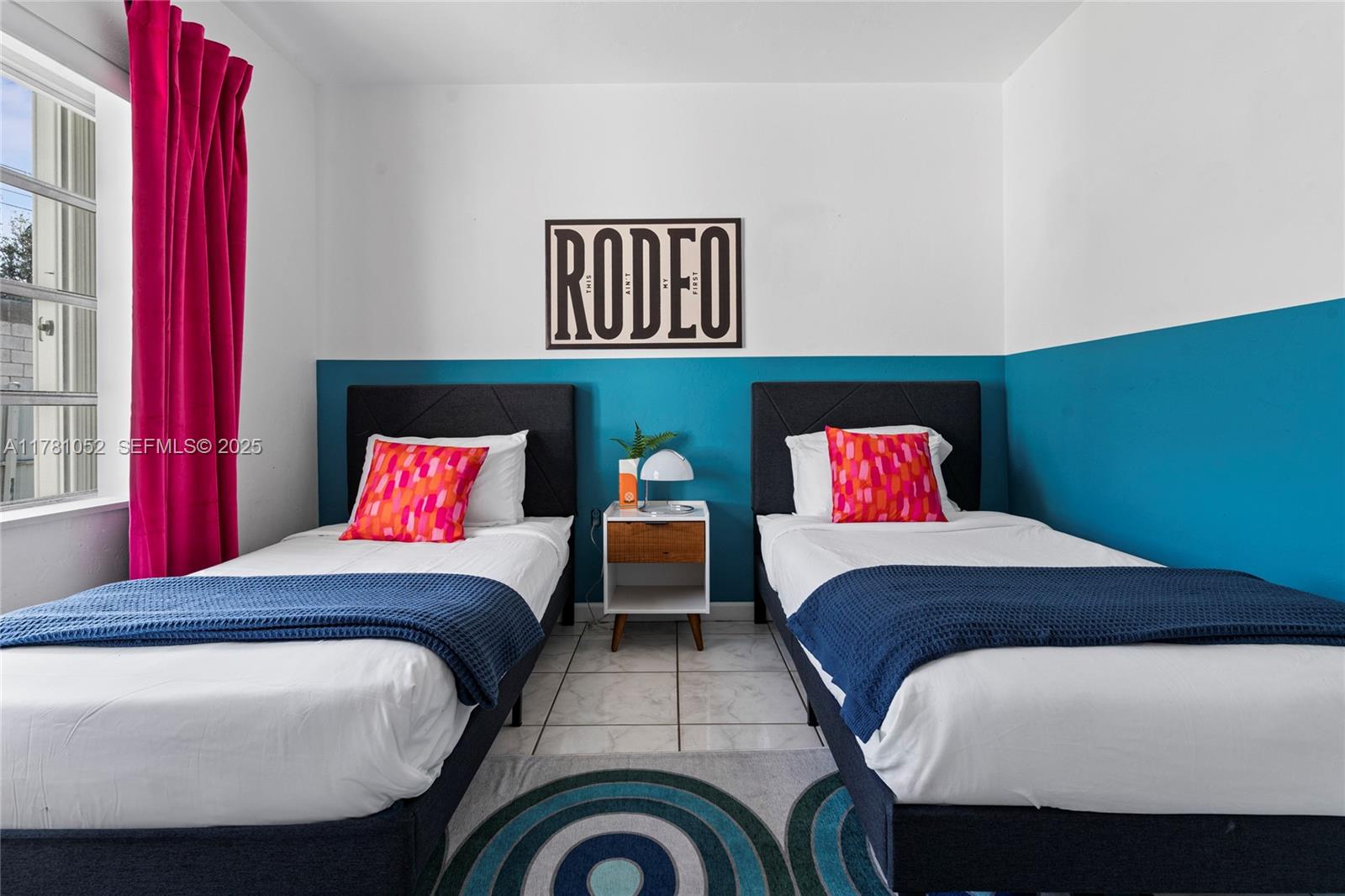 260 Northeast 45th Street Miami, FL 33137 - Photo 16 of 34 a bedroom with a bed and a chandelier