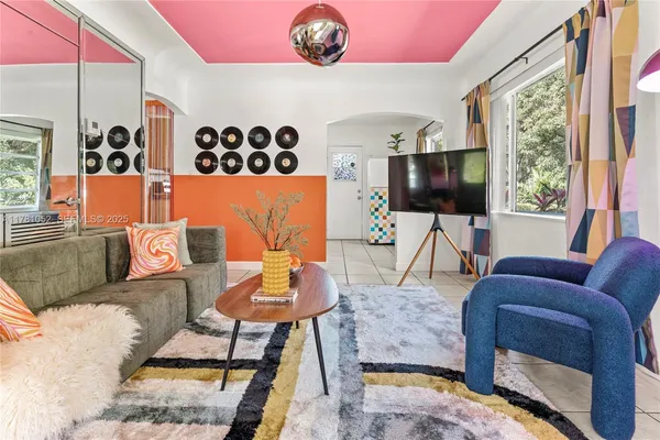 a living room with furniture and a flat screen tv