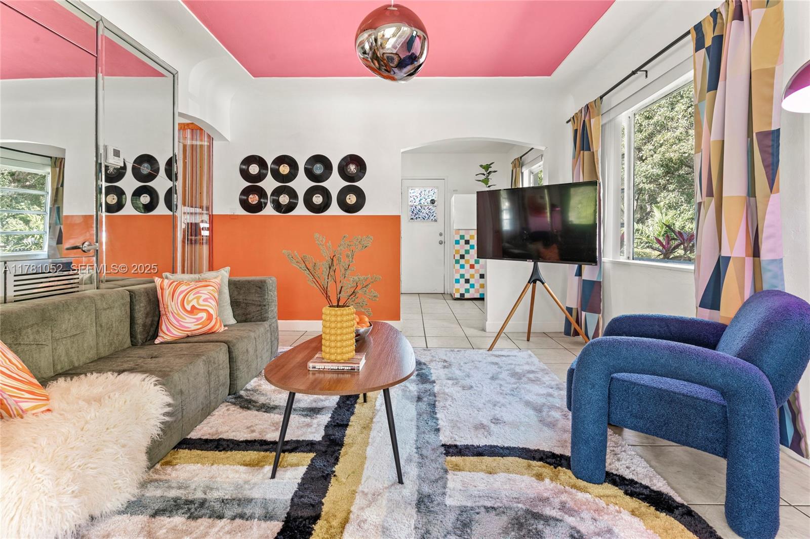 260 Northeast 45th Street Miami, FL 33137 - Photo 2 of 34 a living room with furniture and a flat screen tv