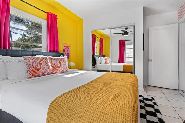 a bedroom with a bed and flat screen tv
