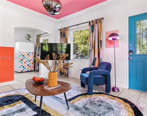 a living room with furniture a rug and a table
