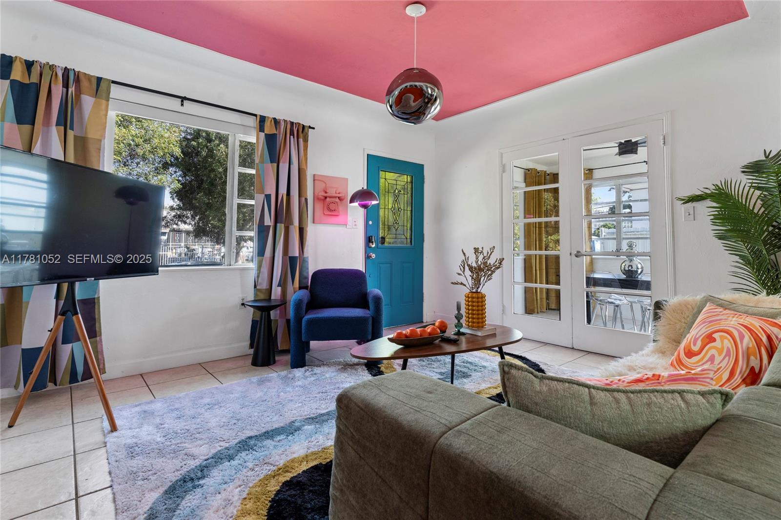 260 Northeast 45th Street Miami, FL 33137 - Photo 4 of 34 a living room with furniture and a flat screen tv