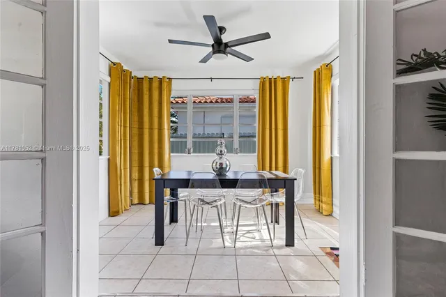 a view of a dining room with furniture and a window