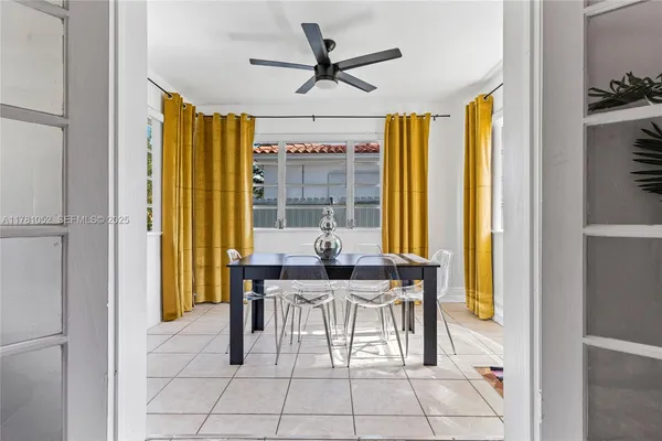 a view of a dining room with furniture and a window