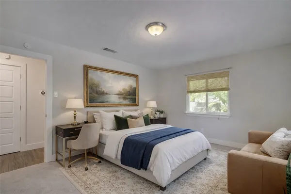 a bedroom with a bed and a couch