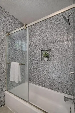 a bathroom with a shower and a sink