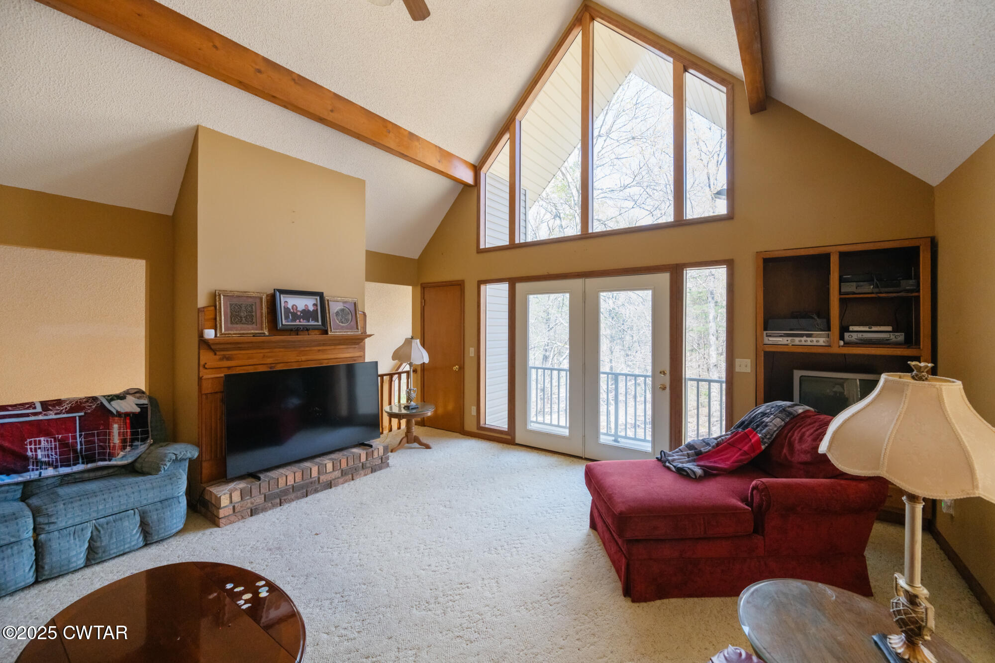 48 Old Pump Station Road Linden, TN 37096 - Photo 31 of 49 a living room with furniture a flat screen tv and a fireplace