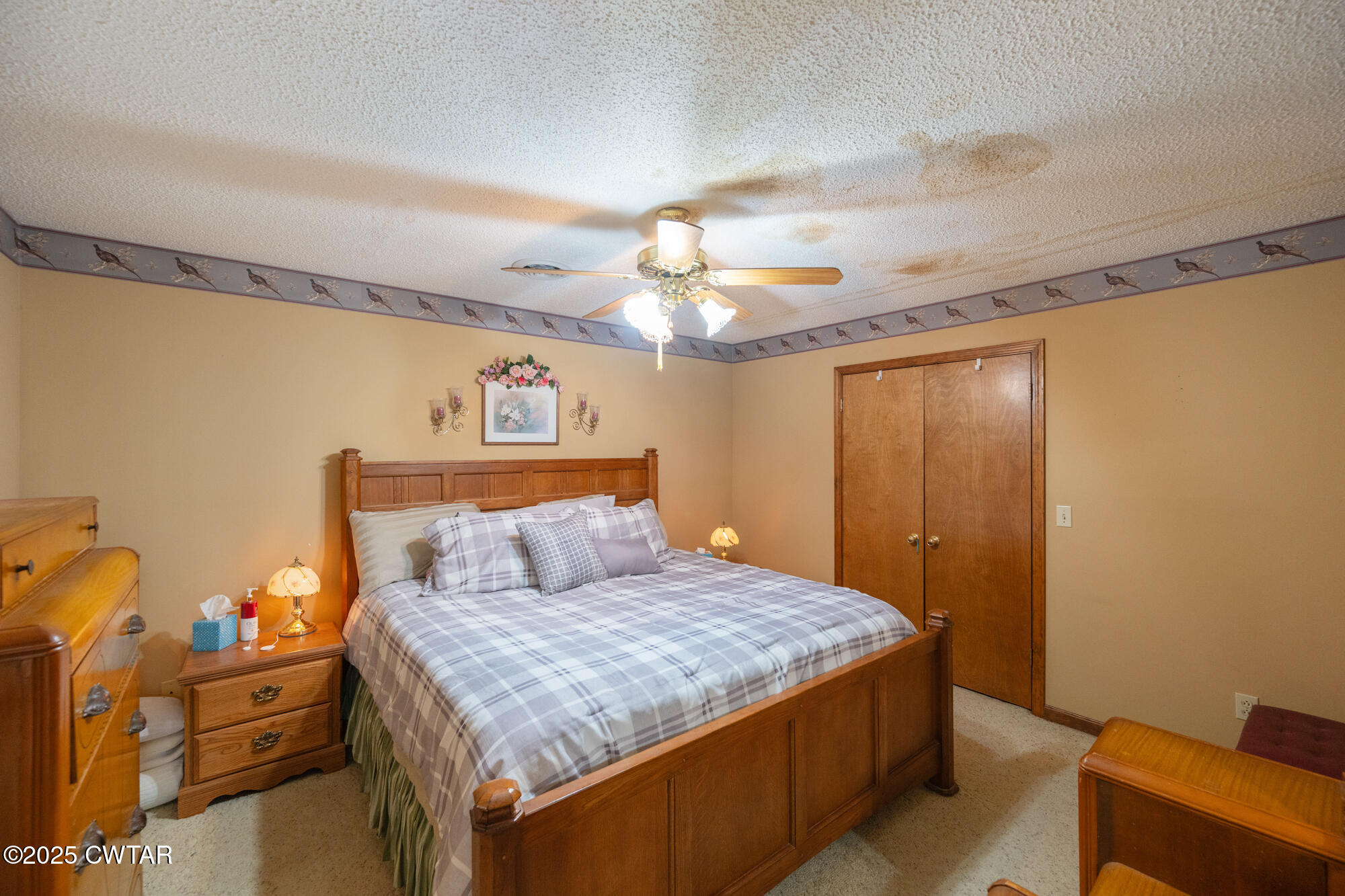 48 Old Pump Station Road Linden, TN 37096 - Photo 37 of 49 a bedroom with a bed and a chandelier