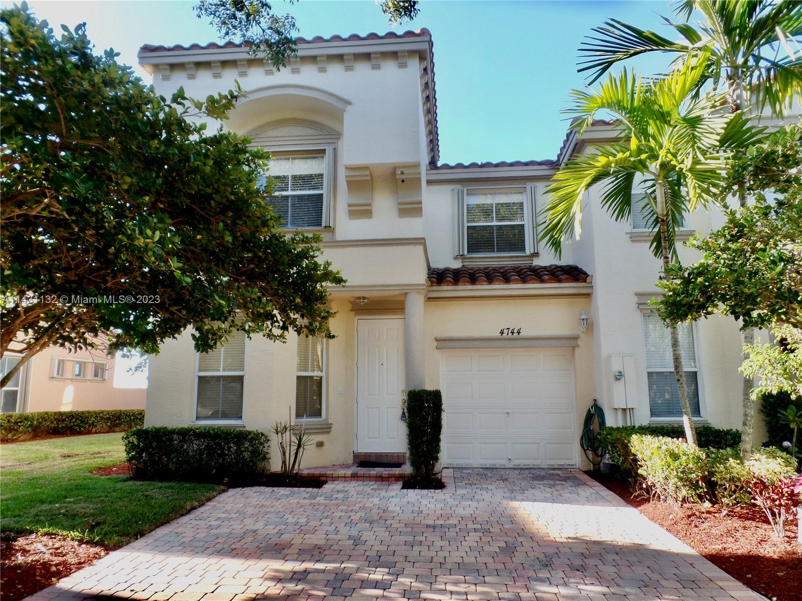 4744 Southwest 165th Avenue, Unit 4744 Miramar, FL 33027 - Photo 1 of 34 a front view of a house with a garden