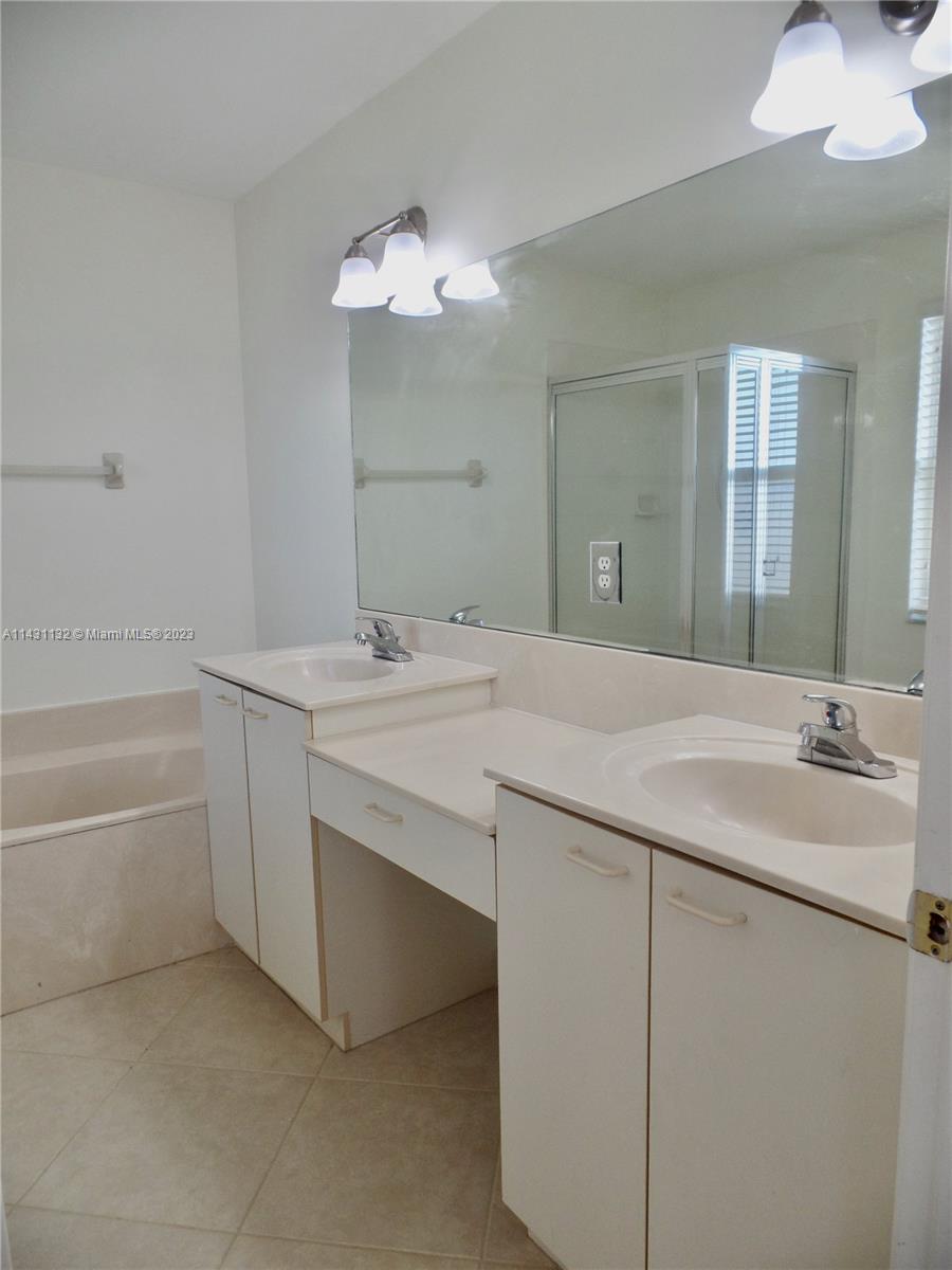 4744 Southwest 165th Avenue, Unit 4744 Miramar, FL 33027 - Photo 12 of 34 a bathroom with a sink and a mirror