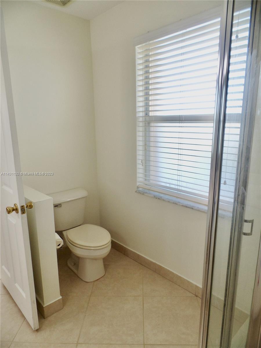 4744 Southwest 165th Avenue, Unit 4744 Miramar, FL 33027 - Photo 14 of 34 a white toilet sitting next to a window